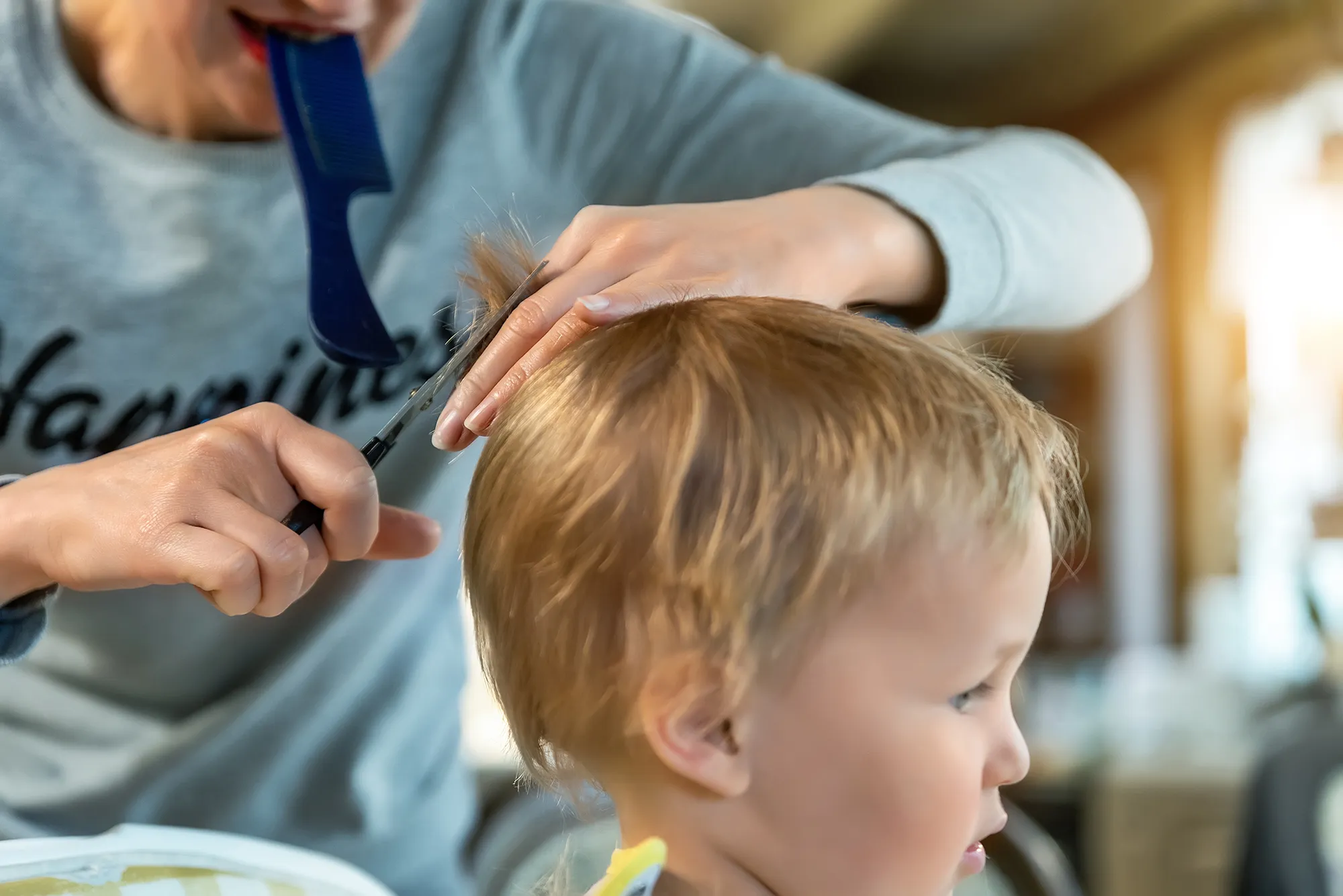 student cutting a persons hair in the salon