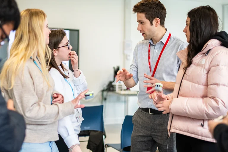 College open event with lecturer explaining course information to prospective students